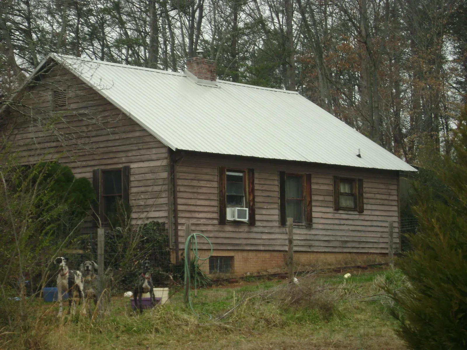 White metal roof on an old wood sided farmhouse, from a Metal Roof Installation job in Plantersville